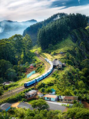 Scenic view of a misty hill station with lush green mountains and cozy cottages – JSBT Holidays