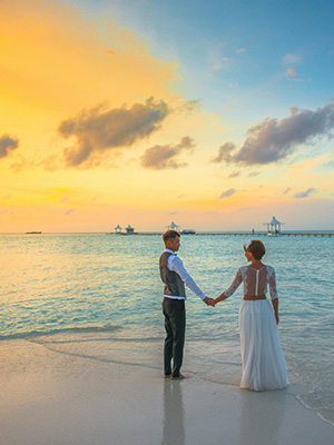 Romantic couple enjoying sunset views by a scenic lake or beach – JSBT Holidays